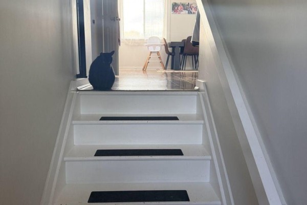 White staircase with black treads leading to an open doorway. - 216 - 220 Erie Street, Port Colborne