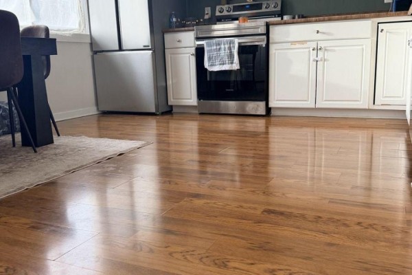 Gleaming hardwood floors in a kitchen area with stainless steel appliances. - 216 - 220 Erie Street, Port Colborne