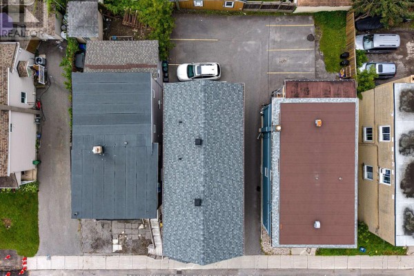 Aerial view showing the rooftop and rear parking area of the property at 216 Carillon Street. - 216 Carillon Street, Ottawa