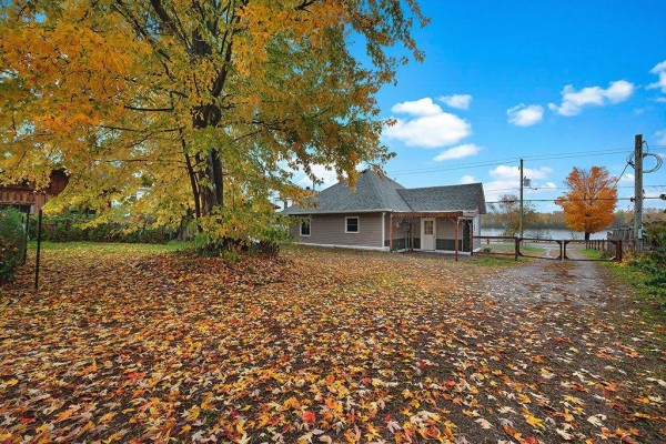 Kitchen with white cabinets, wooden countertops, stainless steel oven, and a window overlooking trees. - 216 Ch. Des Outaouais, L Ile Du Grand Calumet