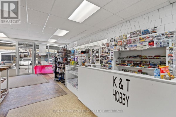 Interior view of a retail store with a counter, shelves, and merchandise. - 216 King Street, Port Colborne