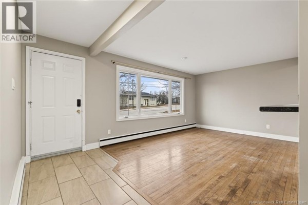The entrance area with beige floor tiles and a doorway to the living space. - 217 Canterbury Avenue, Riverview