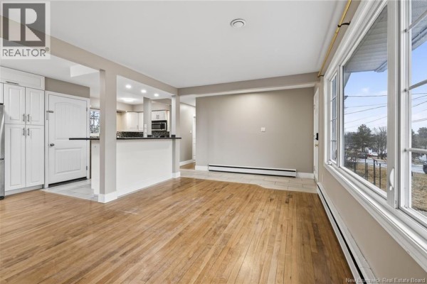 The living room and dining area featuring hardwood floors and large windows. - 217 Canterbury Avenue, Riverview