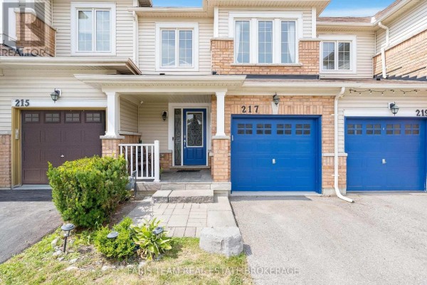 Close-up of the front entrance of 217 Orr Drive with beige siding and brick accents. - 217 Orr Drive, Bradford West Gwillimbury