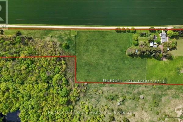 Aerial view showing property boundaries with fields, trees, and a pond. - 217590 Concession 3 Concession, Georgian Bluffs