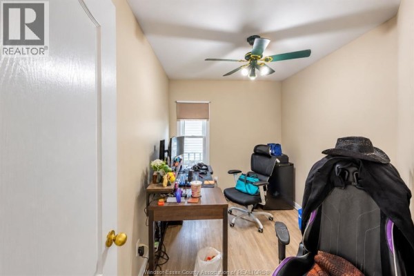 Small room with beige walls, desk with computer, gaming chair, and window. - 2176 Mcdougall, Windsor