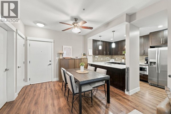 Apartment entryway and dining area with a table set for four, adjacent to the kitchen. - 218 2495 Wilson Avenue, Port Coquitlam