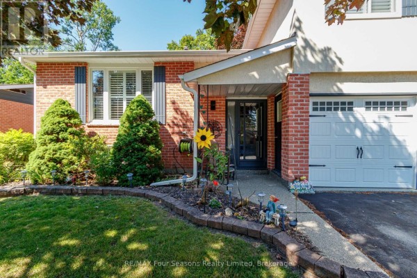 Entryway with staircase, wall-mounted light, and wooden bench. - 218 Datas Drive, Clearview