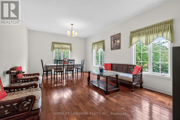 Living and dining room with hardwood floors, wooden furniture, and large windows. - 218 Ridgecrest Road, Markham