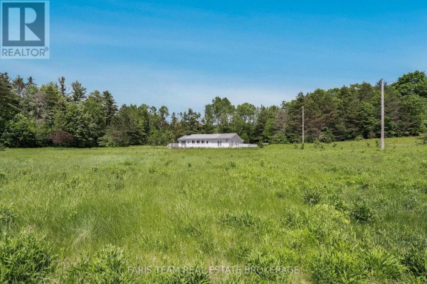 Close-up of windows in an unfinished room with views of greenery. - 2180-2186 Hwy 141, Muskoka Lakes