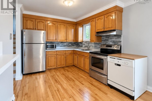 Kitchen features light wood cabinets, stainless steel appliances, a sink, and a wood-counter topped dishwasher. - 2183 Old Sambro Road, Williamswood