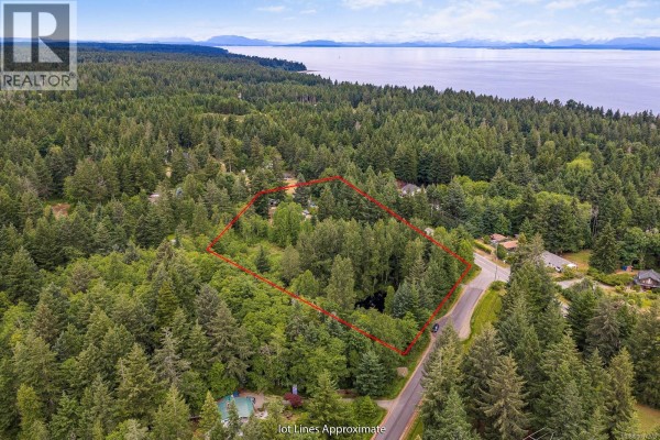 Aerial view of the property with outlined lot lines and ocean in the background. - 2187 May Rd, Courtenay
