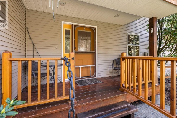 Backyard view featuring a garden area, patio, and trellis structure. - 2187 May Rd, Courtenay
