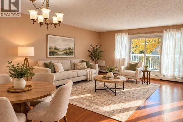 Living and dining area with neutral furniture, rug, and view from window. - 219 960 Assiniboine Avenue E, Regina