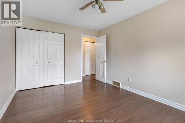 Bedroom with ceiling fan, double closet and hardwood floors - 219 Greenfield Lane Chatham