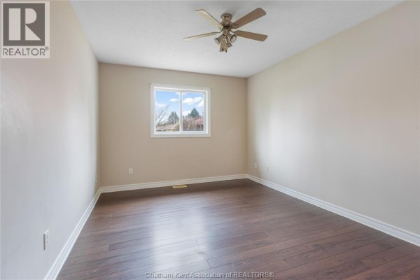Bedroom with hardwood floors and ceiling fan - 219 Greenfield Lane Chatham