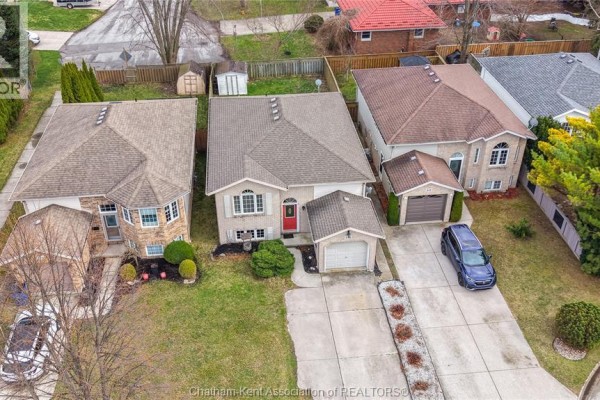 House with red front door and attached garage - 219 Greenfield Lane Chatham