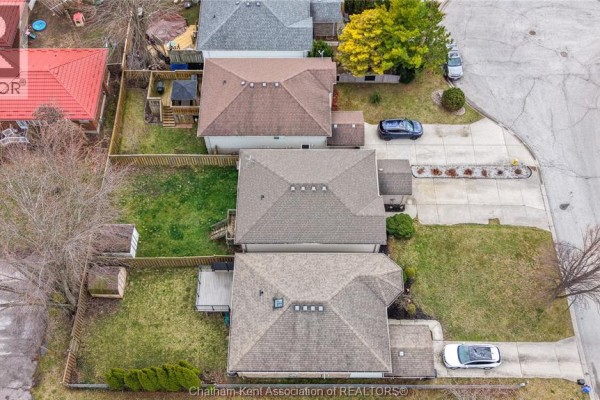 Aerial view of houses with garages, driveways, and yards - 219 Greenfield Lane Chatham