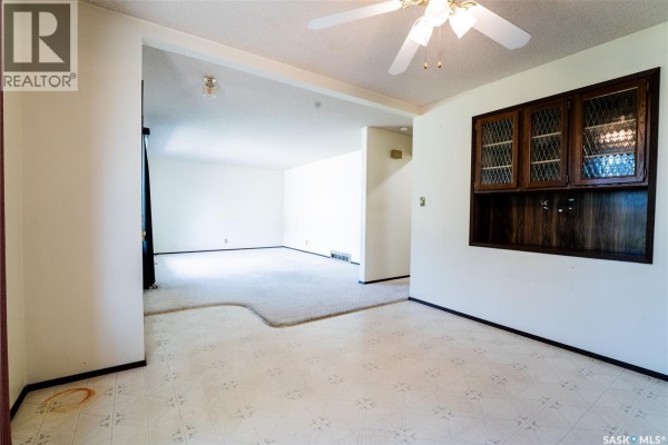 Dining area with a ceiling fan and a view into the living room. - 219 Railway Avenue W, Blaine Lake