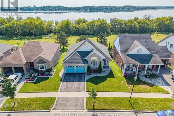 Aerial view showing the house and waterfront view with neighboring properties. - 219 Waterbury Crescent, Scugog