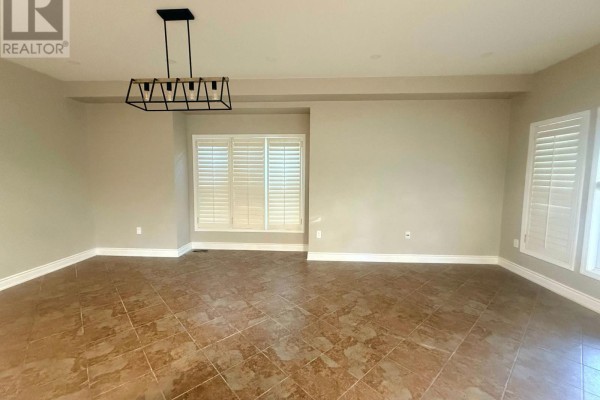 Kitchen with cherry wood cabinets, stainless steel gas stove, and tiled backsplash. - 2198 Woodglen Crescent, Burlington