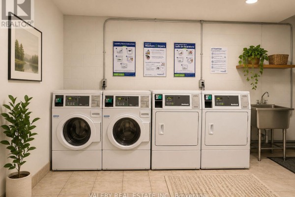 Communal laundry room with washers, dryers, and a sink. - 22 - 917 Hamilton Road, London East