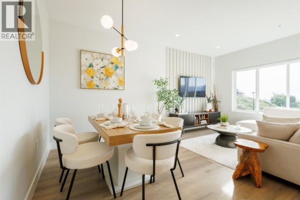 Dining area with a light wood table and plush chairs, adjacent to a living room. - 22 10640 248 Street, Maple Ridge