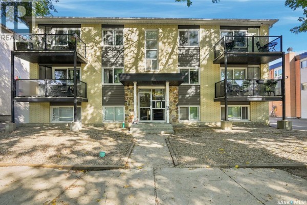 Exterior front view of a light yellow brick apartment building with balconies and entrance. - 22 2157 Rae Street, Regina