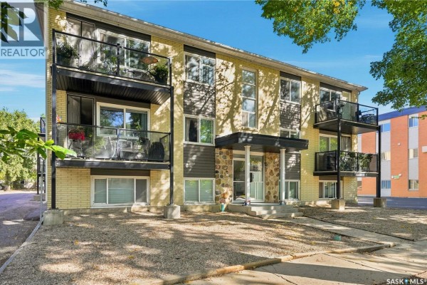 Apartment building exterior with stone accents around the central entrance and multiple balconies. - 22 2157 Rae Street, Regina