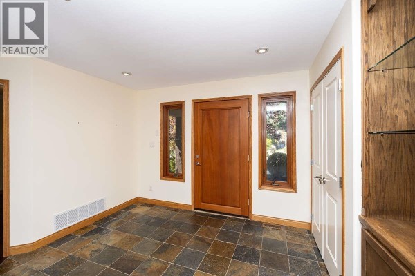 Entryway with slate flooring, large windows, and wooden door - 22 4622 Sinclair Bay Road, Garden Bay