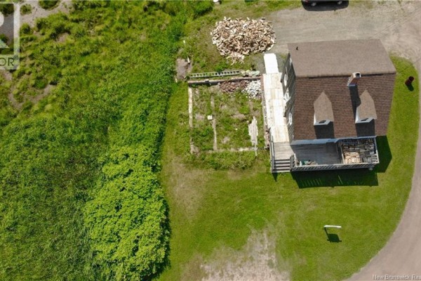 Aerial view highlighting the house and adjacent green space. - 22 Beach Street, Pointe Du Chene