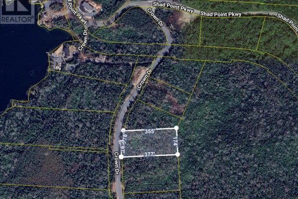Aerial view of a wooded property with a blue lake and scattered houses in the distance. - 22 Crown Drive, Blind Bay