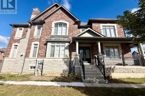 Front exterior of a modern two-story house with stone accents and a prominent covered porch. - 22 Duggan Street, Aurora