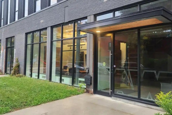 Ground floor entrance with glass doors and large windows offering a view inside. - 22 Geary Avenue, Toronto