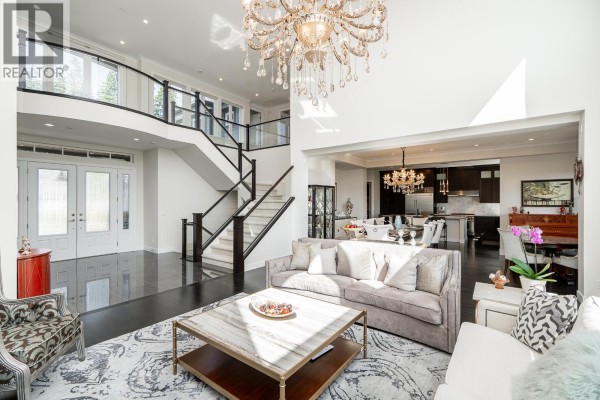 A view from the living room to the entryway, staircase, and dining area. - 22 Heritage Peak Road, Port Moody