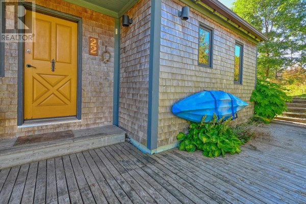 Interior entryway with a wooden door, bench, and tiled floor. - 22 Macken Road, Antigonish Landing