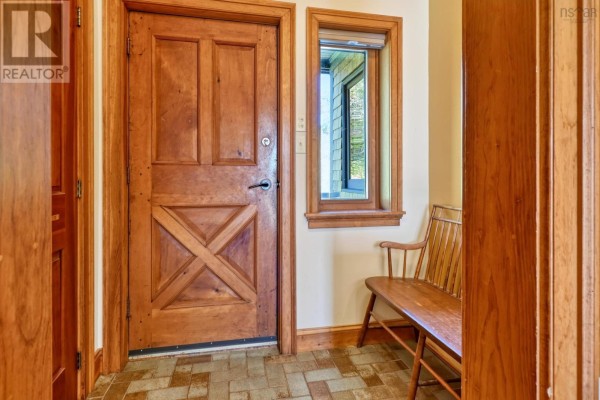Hallway with wood floors, wooden doors, and antique chests. - 22 Macken Road, Antigonish Landing