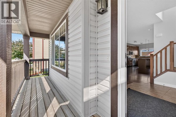 View from the covered porch looking towards the front door and into the home's interior. - 22 Panora Road Nw, Calgary