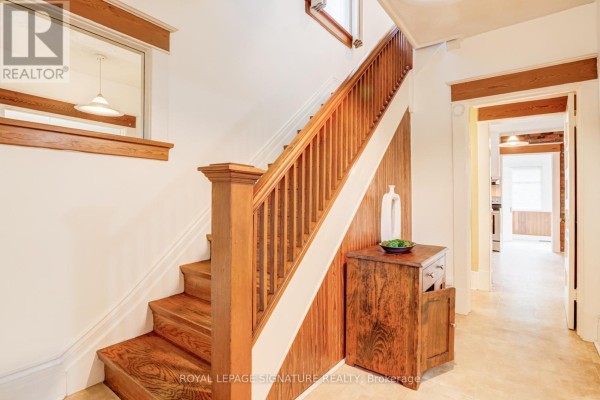 Wooden staircase and hallway with antique cabinet - 22 Peel Avenue Brampton