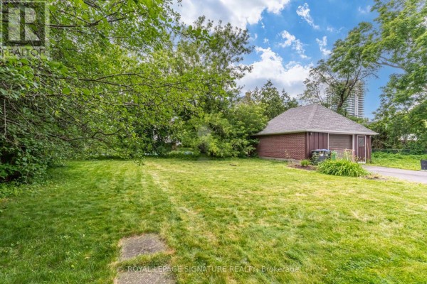 Spacious yard with detached garage and paved driveway - 22 Peel Avenue Brampton
