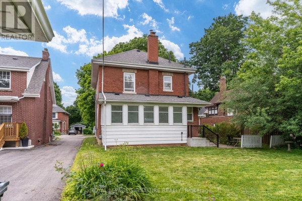 Brick house with sunroom and chimney - 22 Peel Avenue Brampton