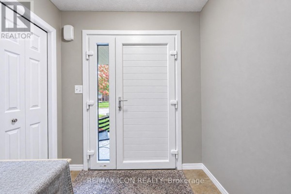 Interior view of the front entrance with a white door and closet, grey walls. - 22 Poffenroth Path, Woolwich