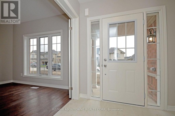 View from inside the foyer, looking towards a large window and the front door area. - 22 Ryan Street, Centre Wellington
