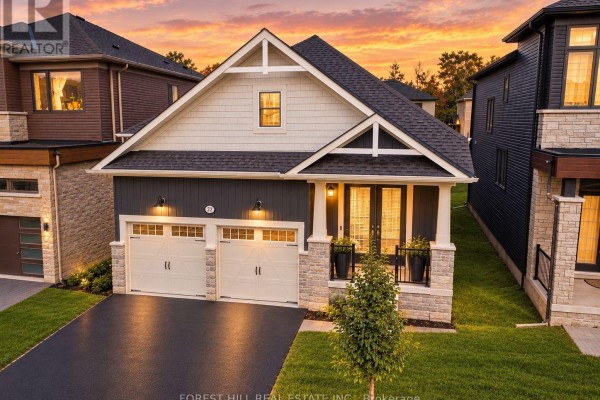 Front view of a modern house at sunset, featuring stone and dark siding. - 22 Simona Avenue, Wasaga Beach