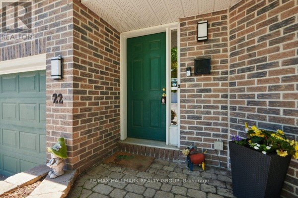 Interior entryway with white door, coat rack, bench, and shoe storage. - 22 Terrace Drive, Ottawa