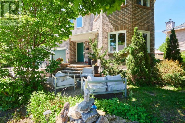Living room with green walls, bay window, sectional sofa, and coffee table. - 22 Terrace Drive, Ottawa