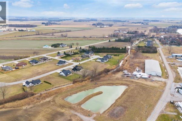 Drone view of a developing subdivision with houses and undeveloped land. - 22 Tyler Drive, Port Lambton