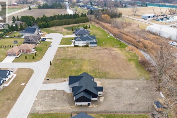 Close-up aerial of a vacant lot next to a house, with more houses visible. - 22 Tyler Drive, Port Lambton