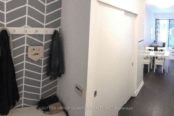 Entryway with coat rack, bench, and gray chevron wallpaper. - 220 - 1030 King Street W, Toronto