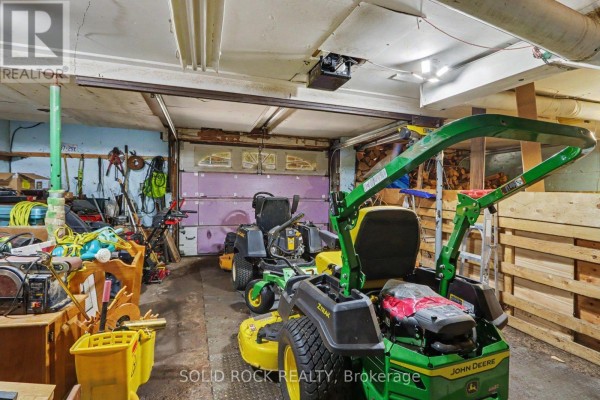 House with red roof, large windows, driveway, and retaining walls - 220 Highfield Crescent Beckwith